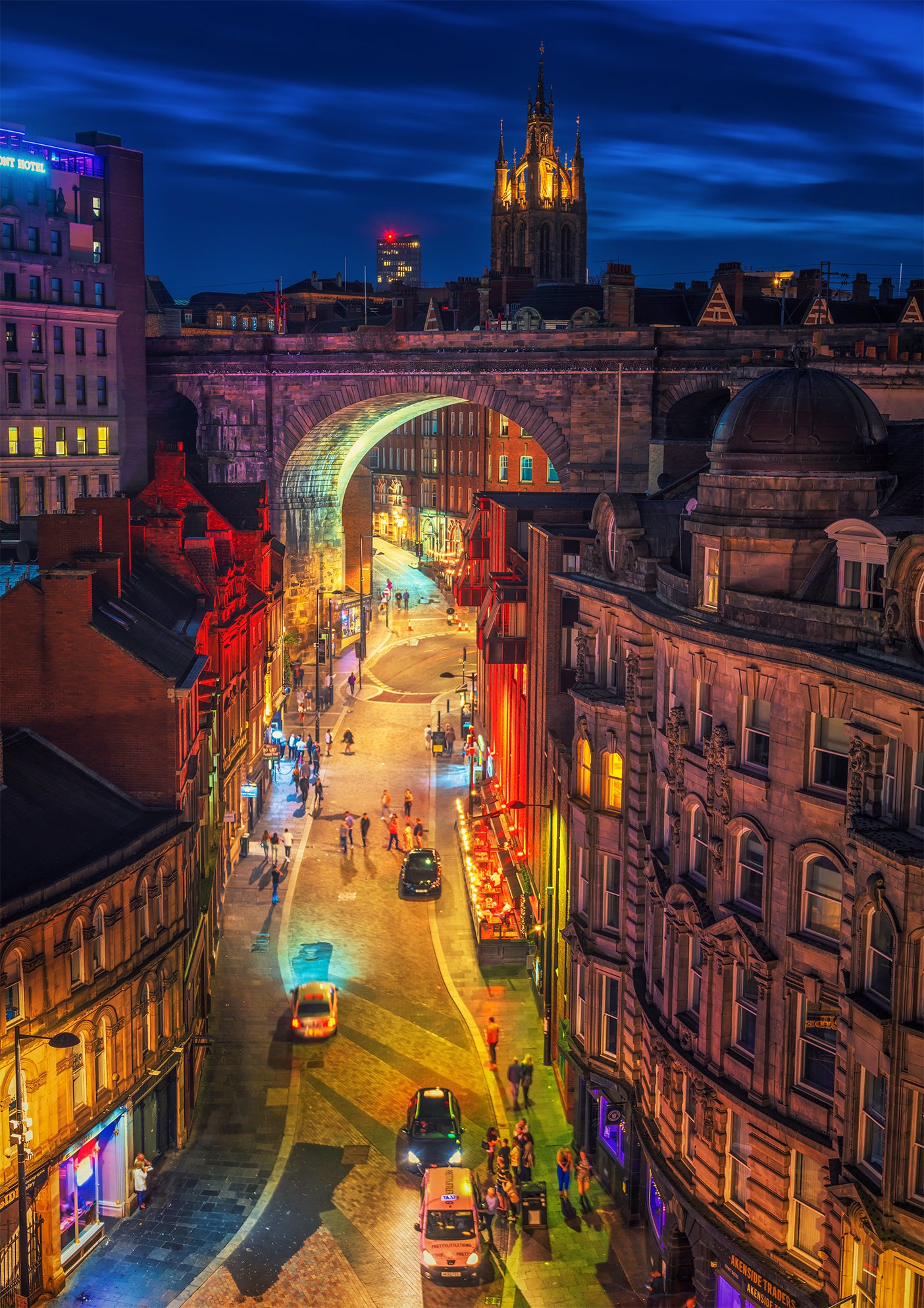 Colourful nighttime scene of Newcastle nightlife.
