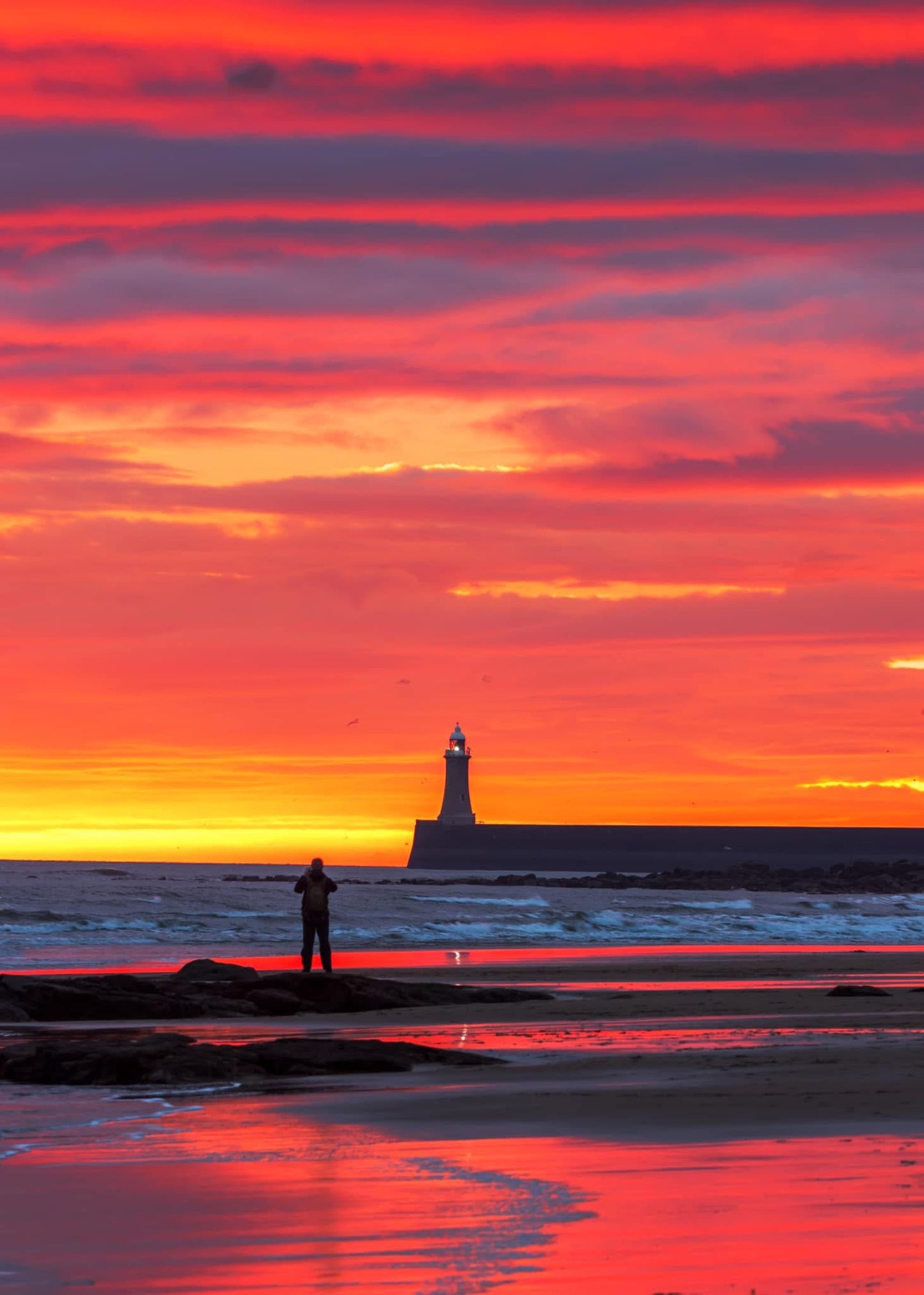 Admiring a beautiful Tynemouth sunrise.