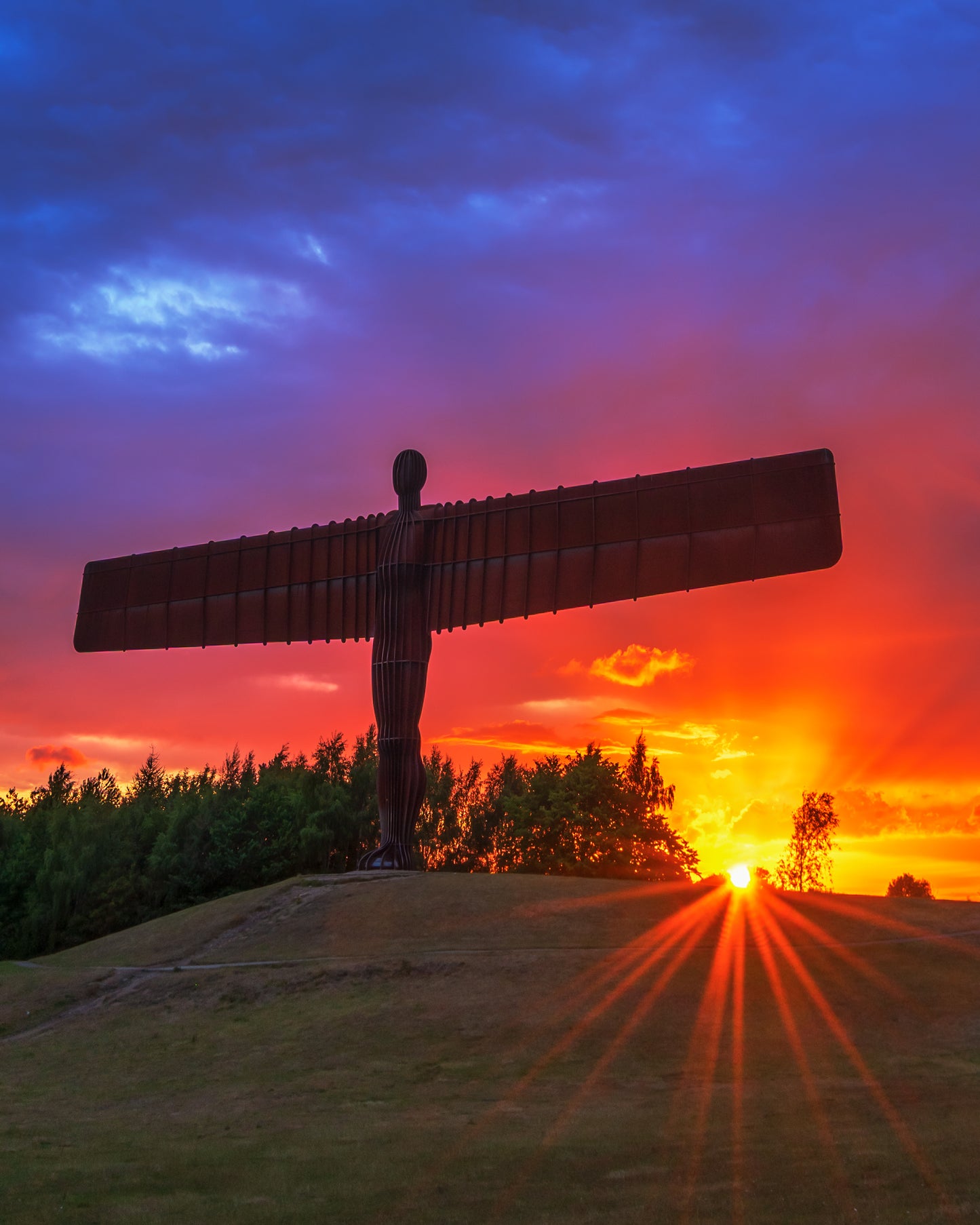 A colourful glowing sunset at the Angel of the North.