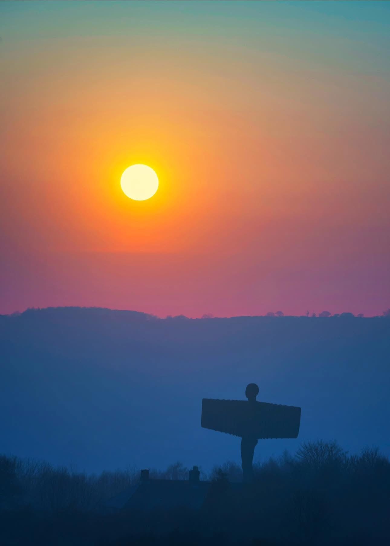 A lovely muted sun over the Angel of the North.