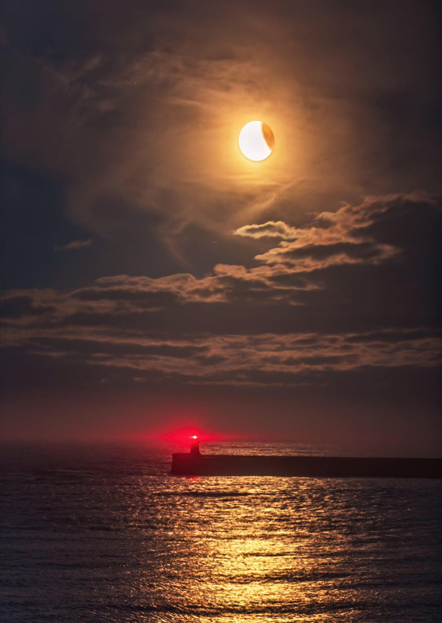 Partial eclipse of the moon over Tynemouth.