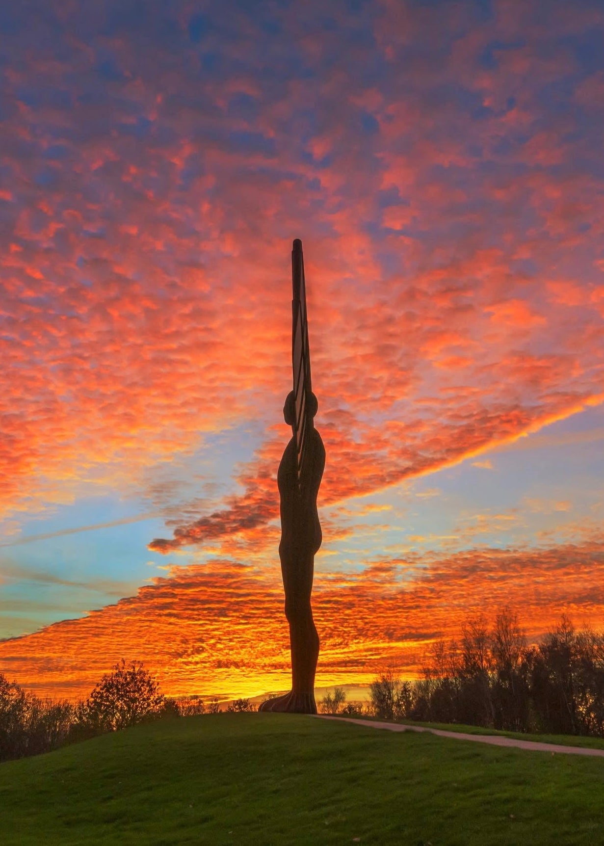 The Angel surrounded by golden lit clouds.