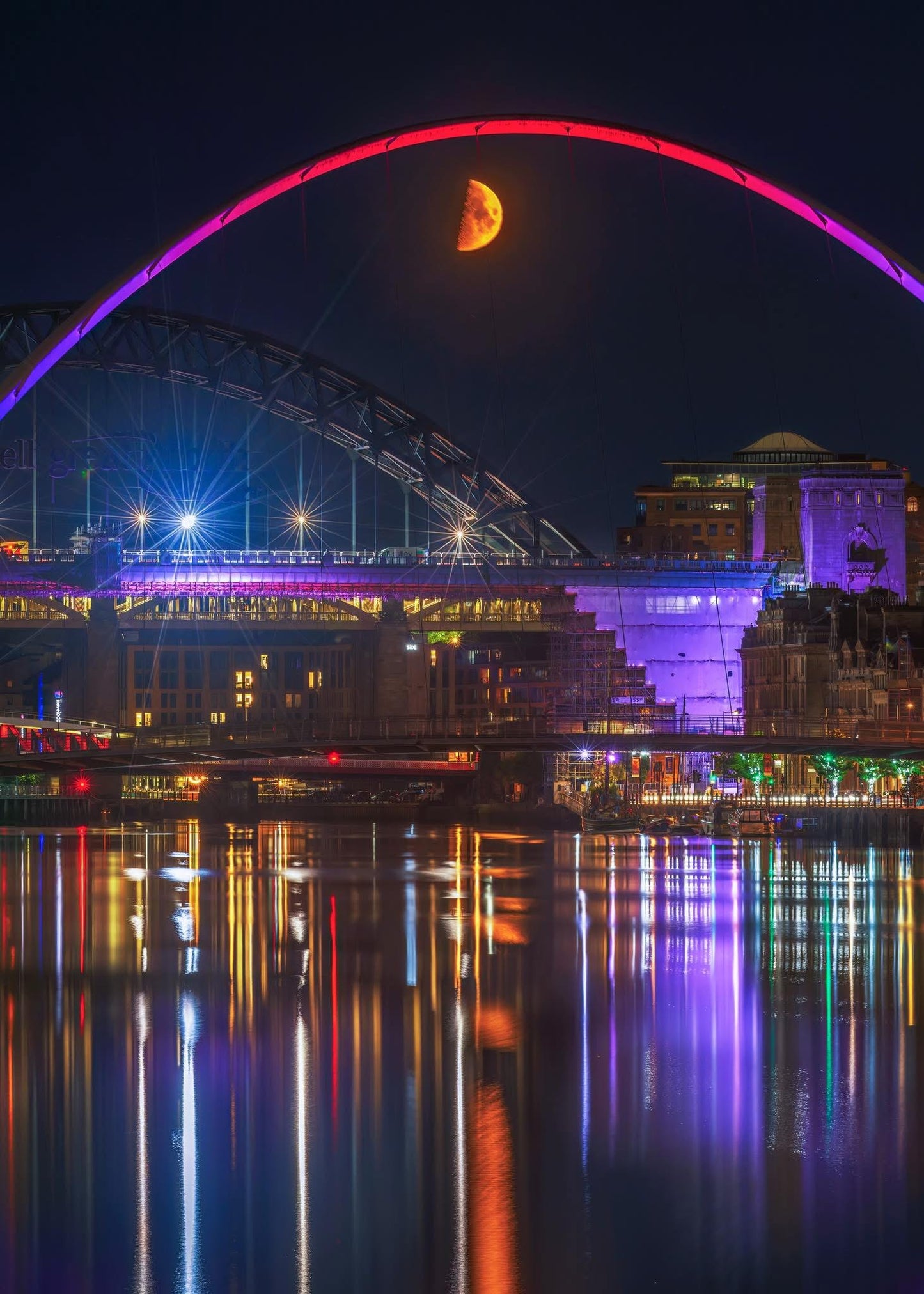 A colourful quayside scene with a crescent moon.