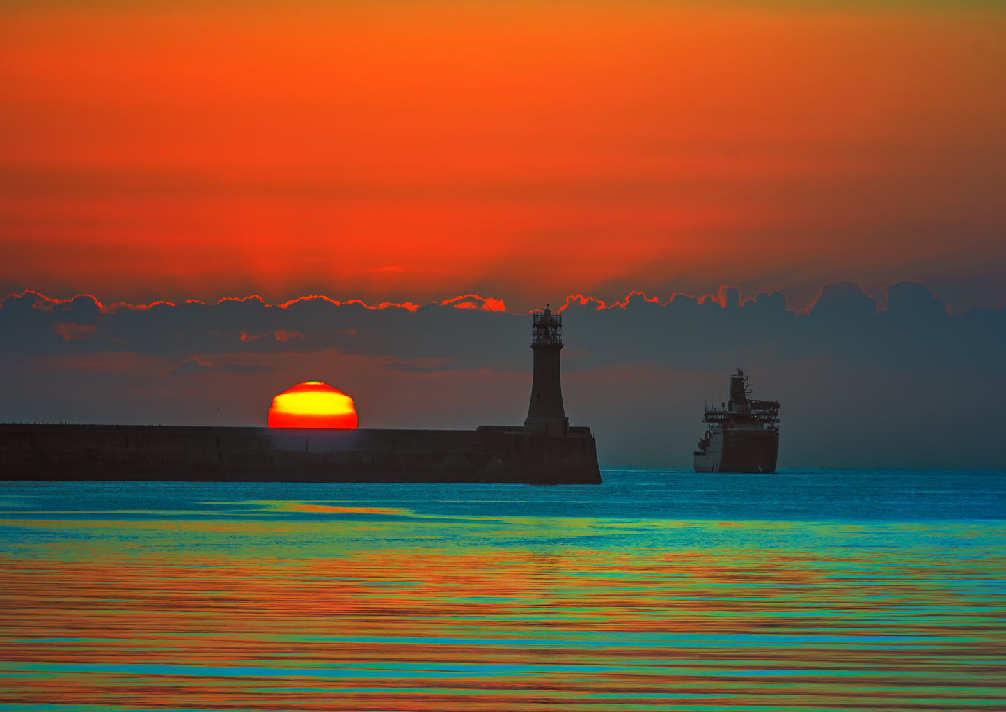 Vibrant colours over Tynemouth Lighthouse at sunrise.