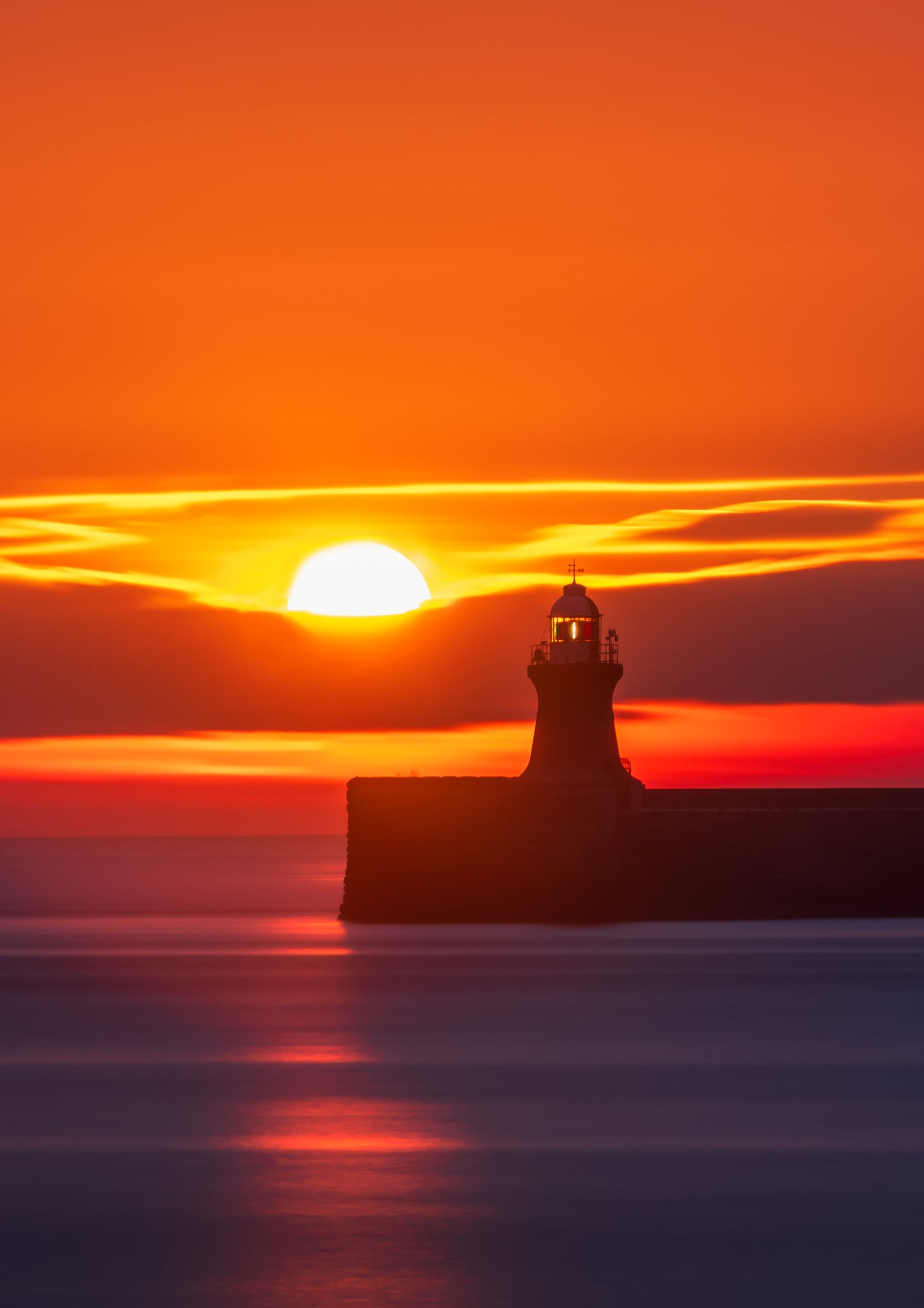 Vibrant sunrise over South Shields lighthouse.