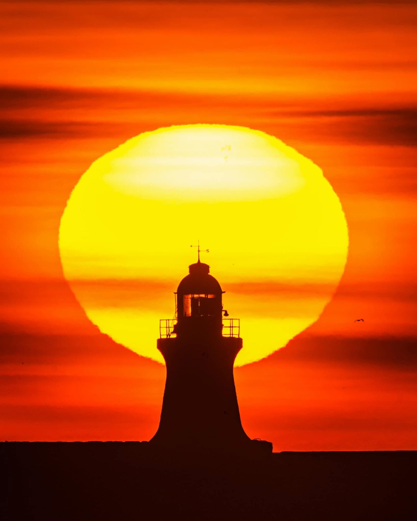 South Shields lighthouse inside the rising sun.