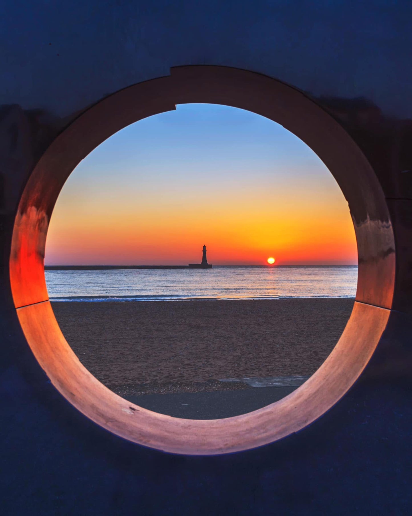 Roker Lighthouse through the porthole.