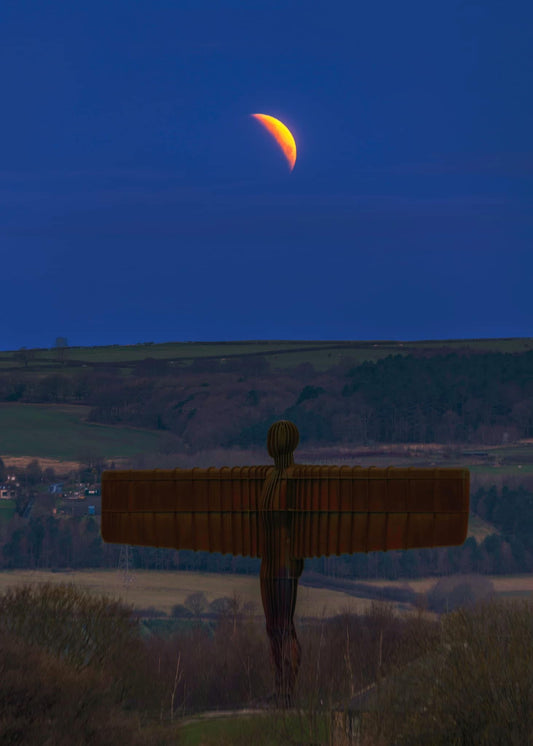 A partial lunar eclipse over the Angel of the North.