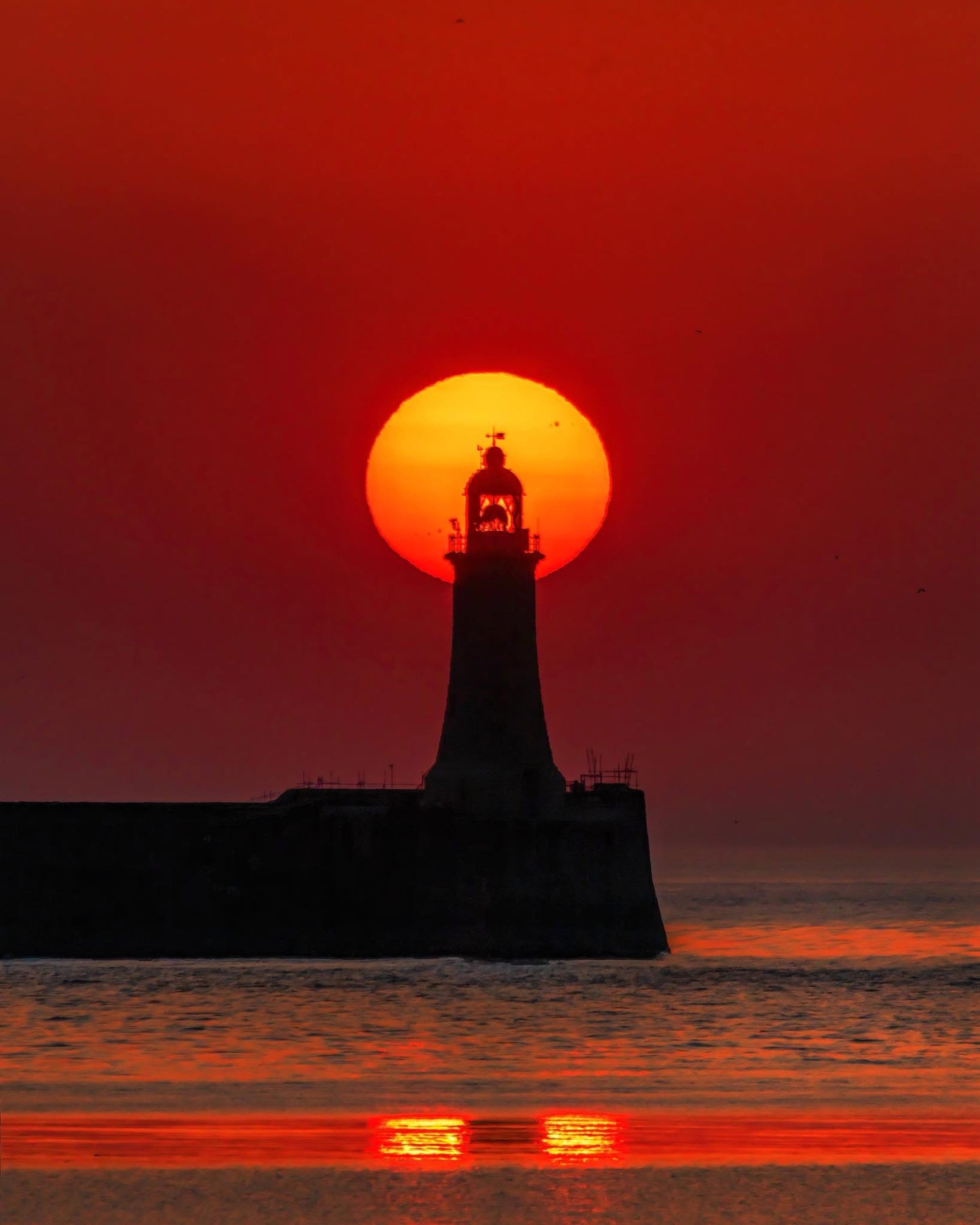 A summer solstice sunrise over Tynemouth Lighthouse.
