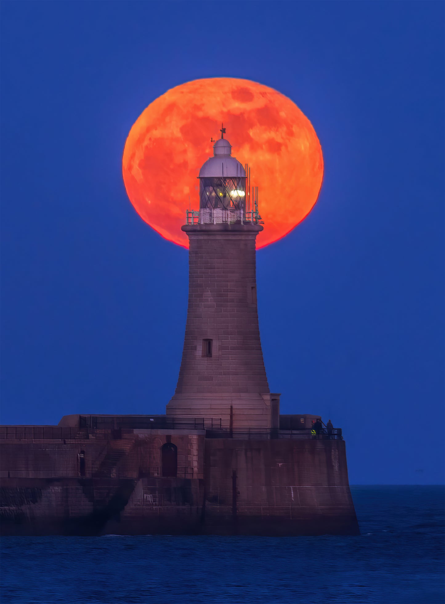 Beautiful red moon over Tynemouth Lighthouse.