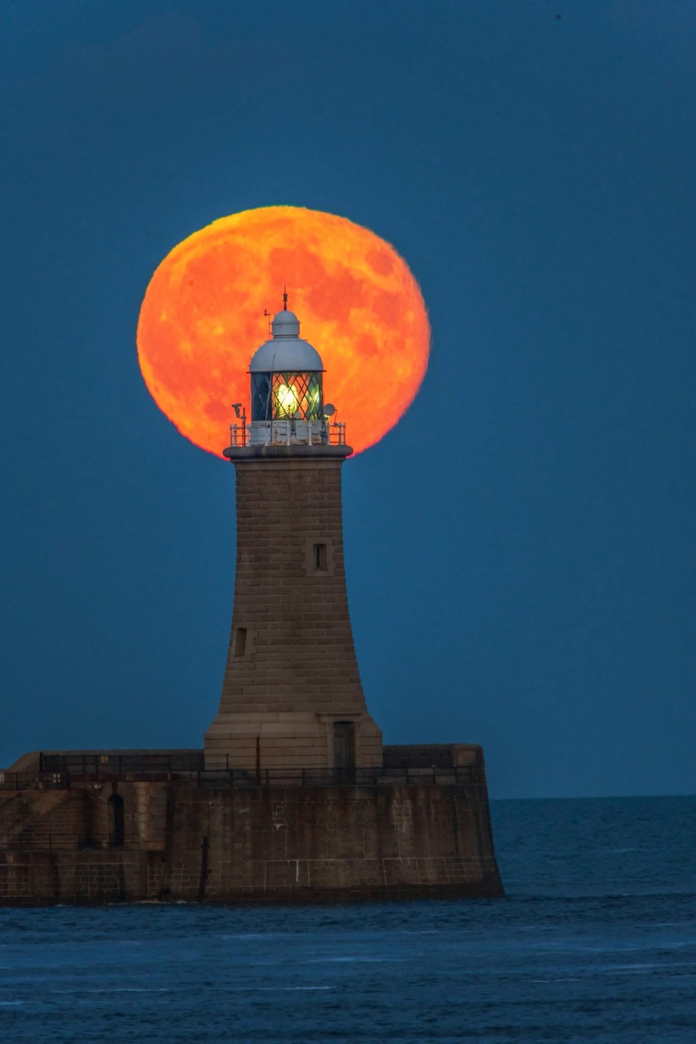 The full moon nestled on Tynemouth Lighthouse.