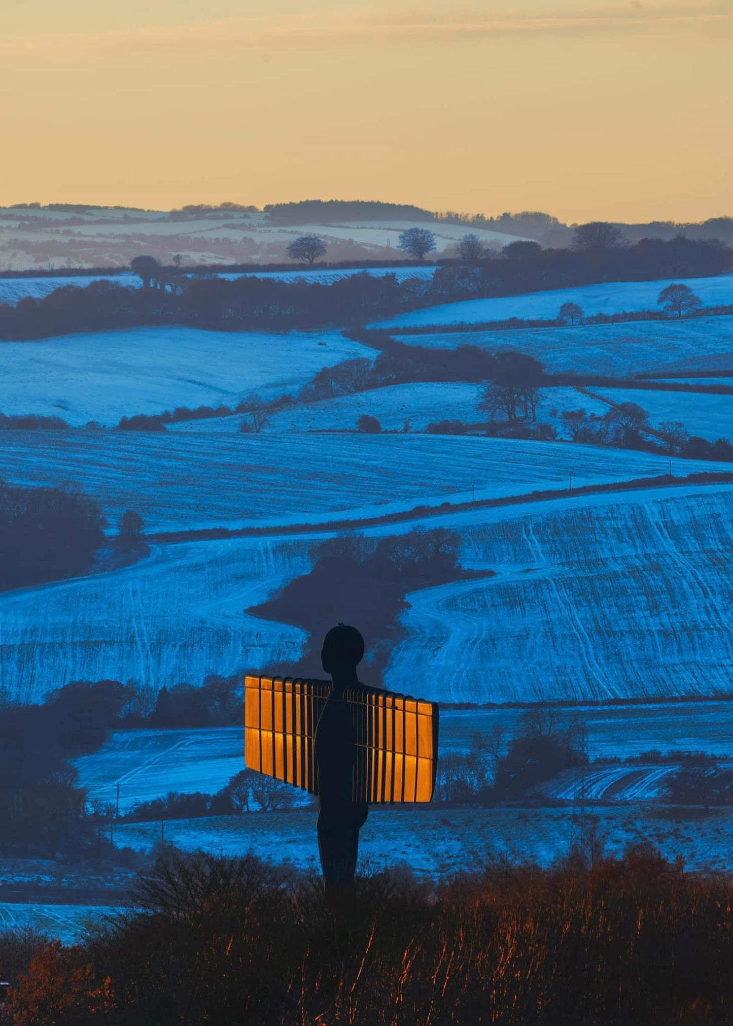 A snowy sunset scene at the Angel of the North.
