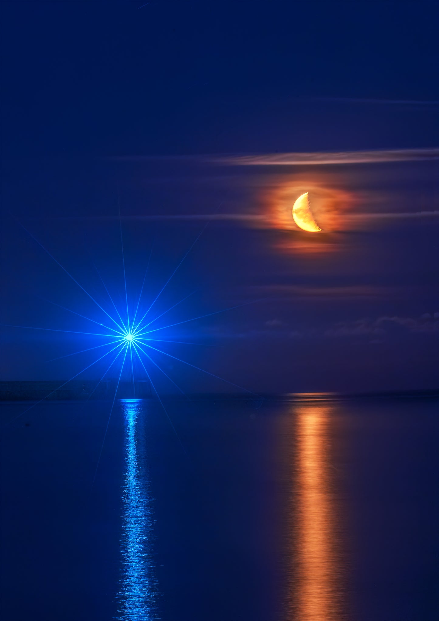 A half moon with Tynemouth Lighthouse