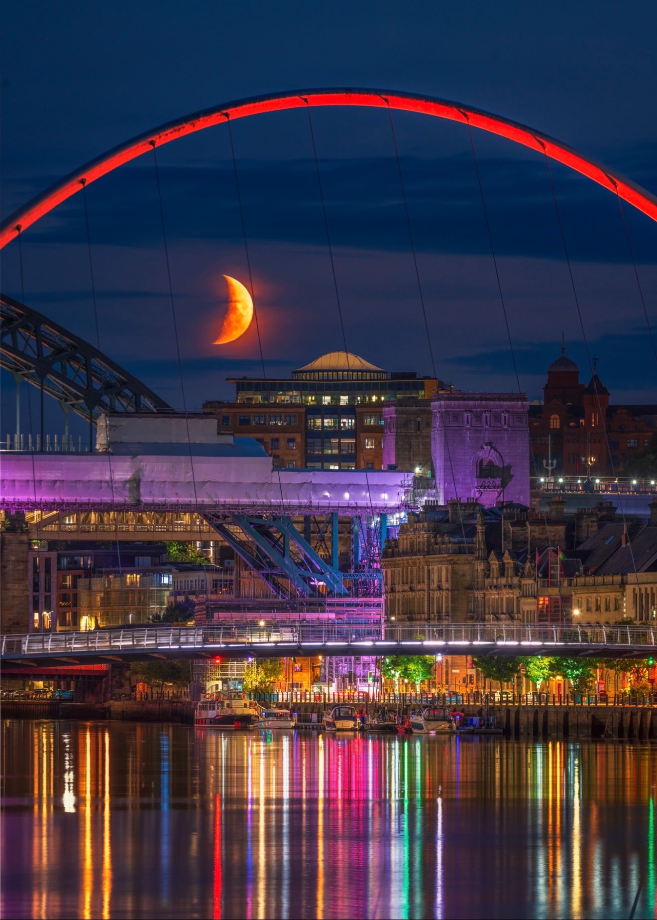 A setting crescent moon on a very colourful Newcastle Quayside.