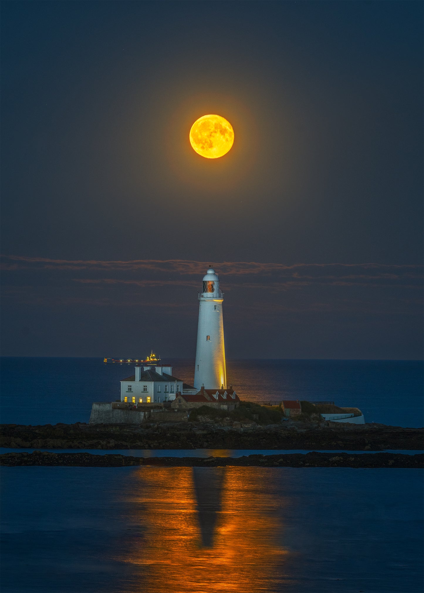 The full moon rising high above St. Mary’s Lighthouse.