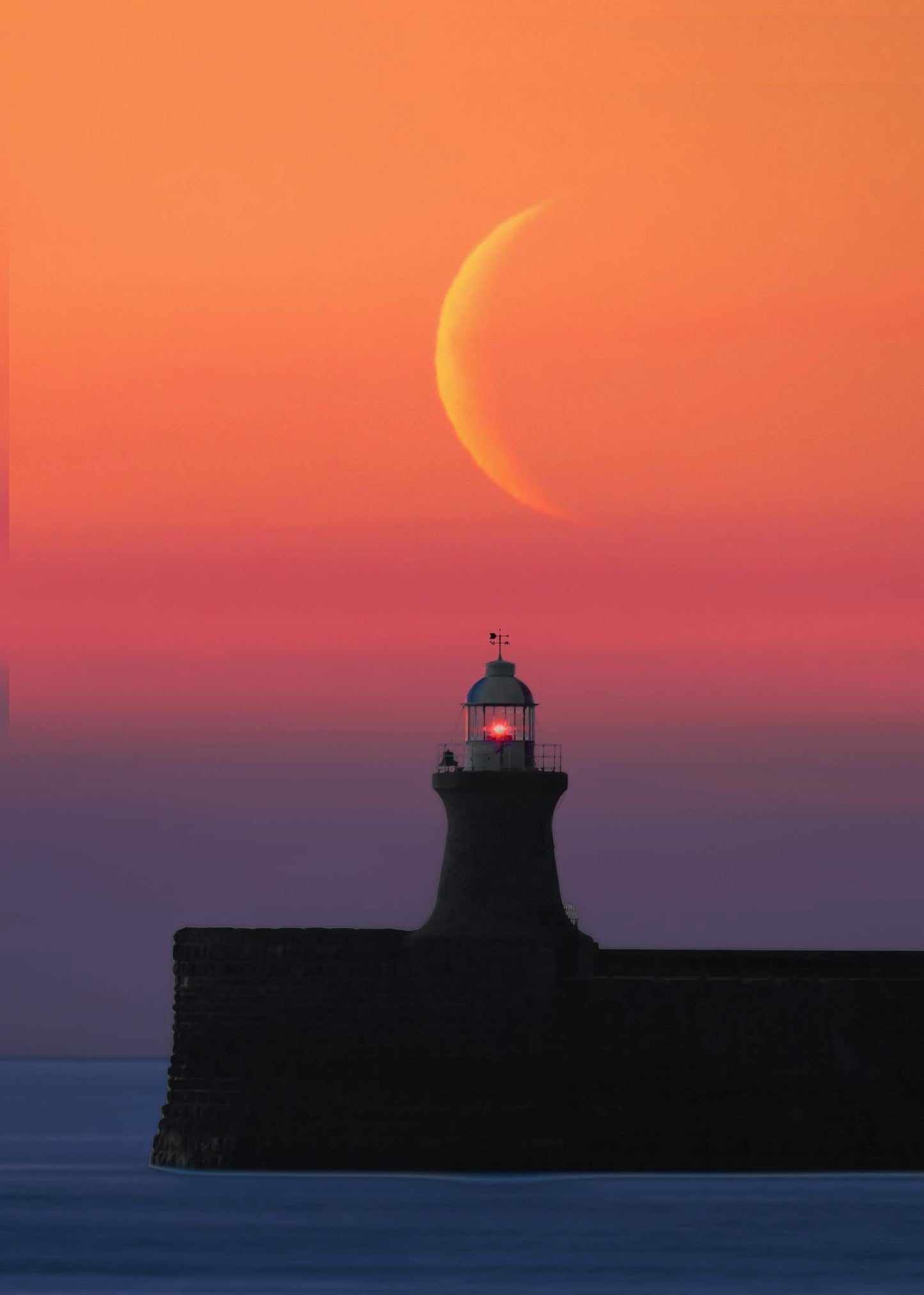 Crescent moon over South Shields Lighthouse.