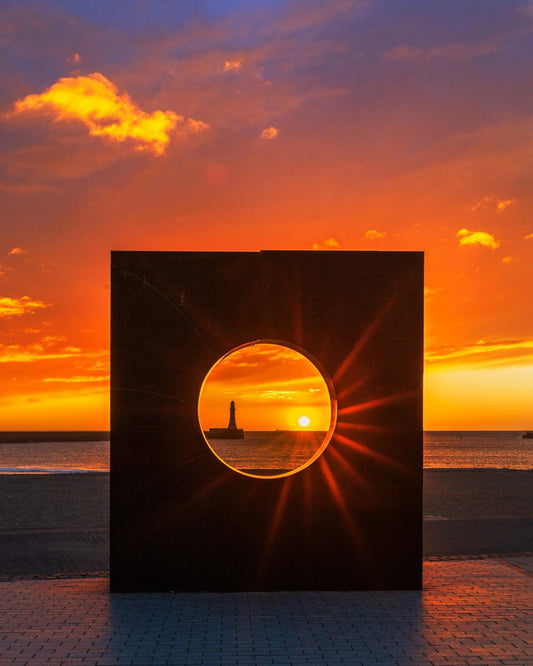 Sunburst through the Roker porthole.