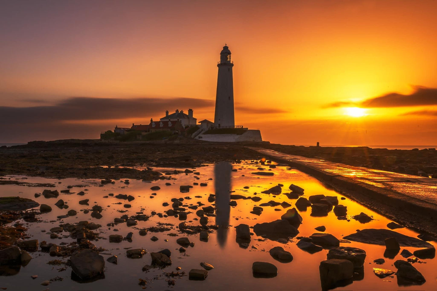 A muted golden sunrise at St.Mary’s Lighthouse