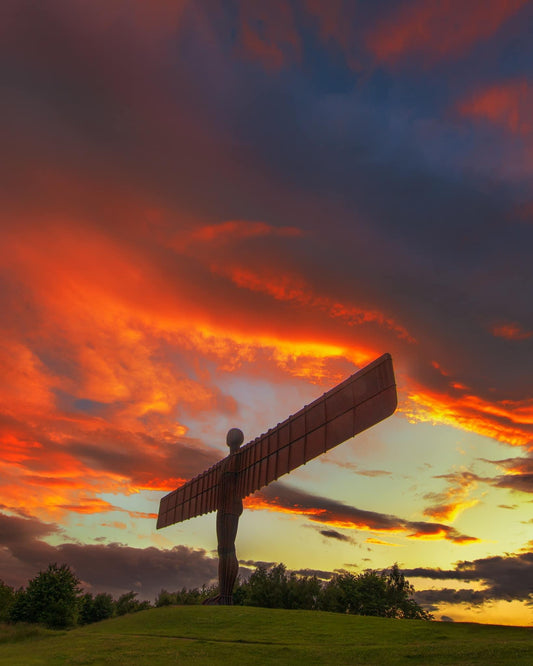 The Angel surrounded by golden lit clouds.