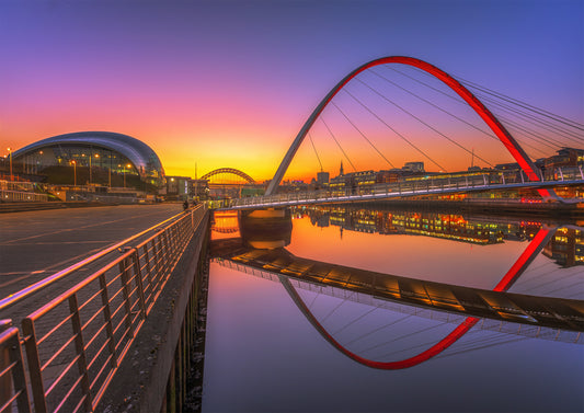 Glowing sunset colours behind Millennium Bridge.