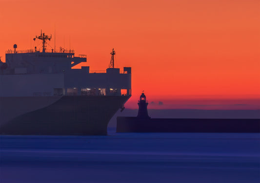 The United Spirit towering over South Shields Lighthouse as it comes in to port.