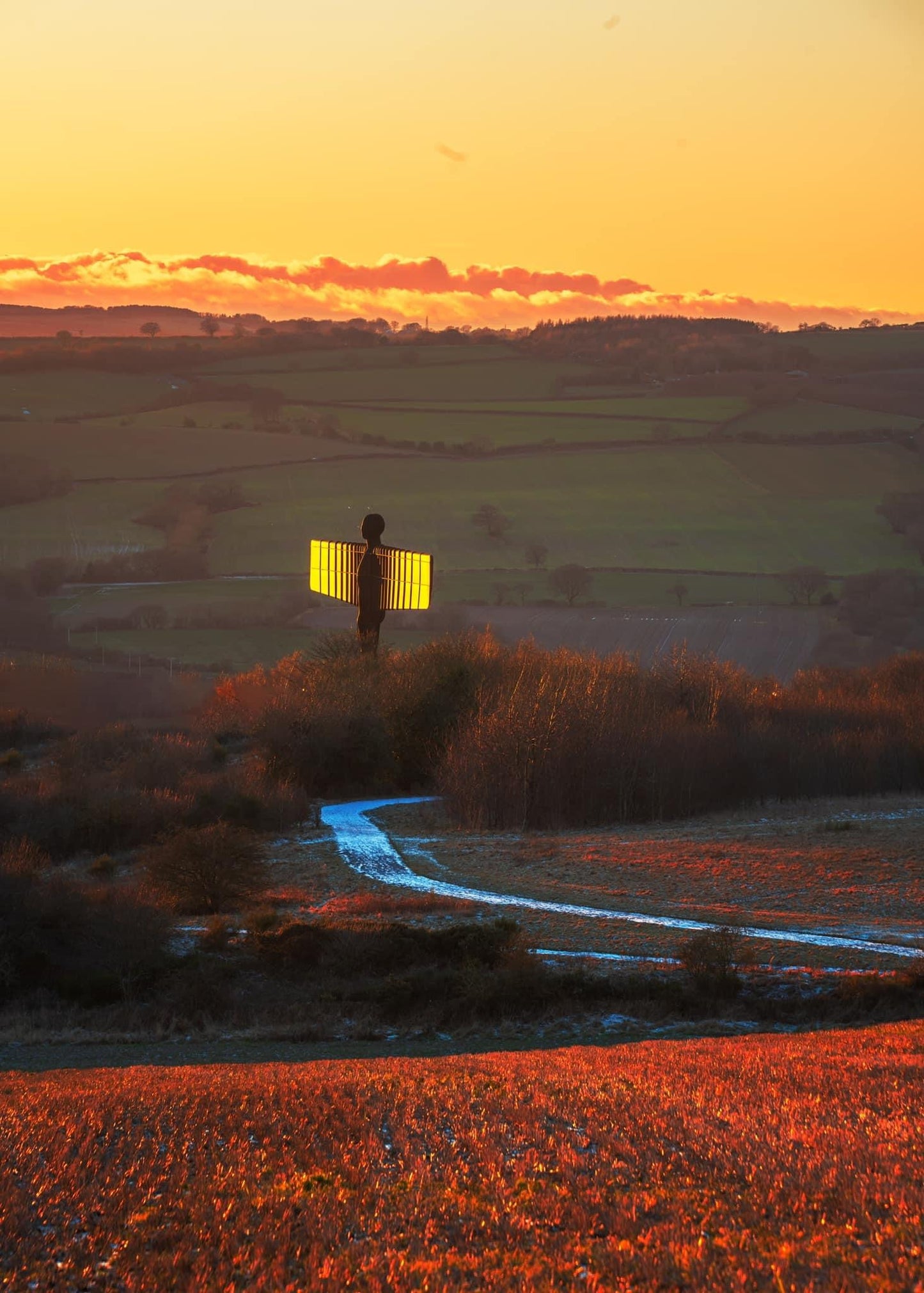 A glowing Angel of the North just before sunset.