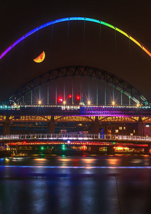 A half moon over a very colourful quayside.