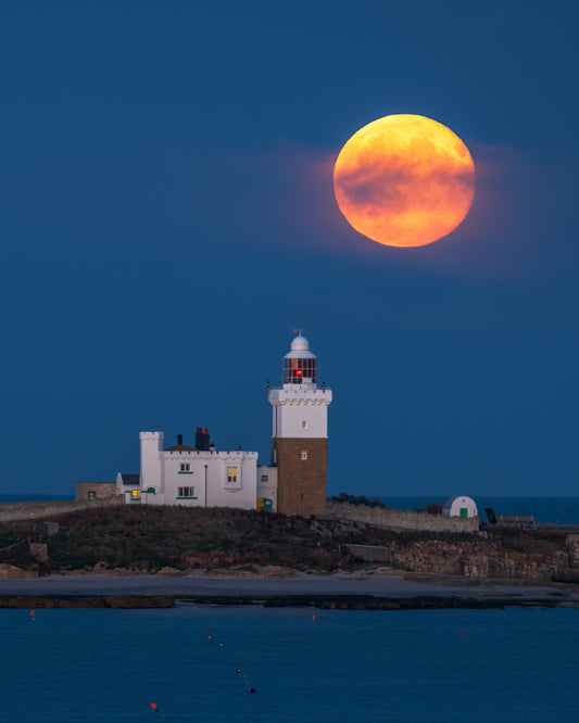 Hazy moonrise over Coquet Lighthouse.