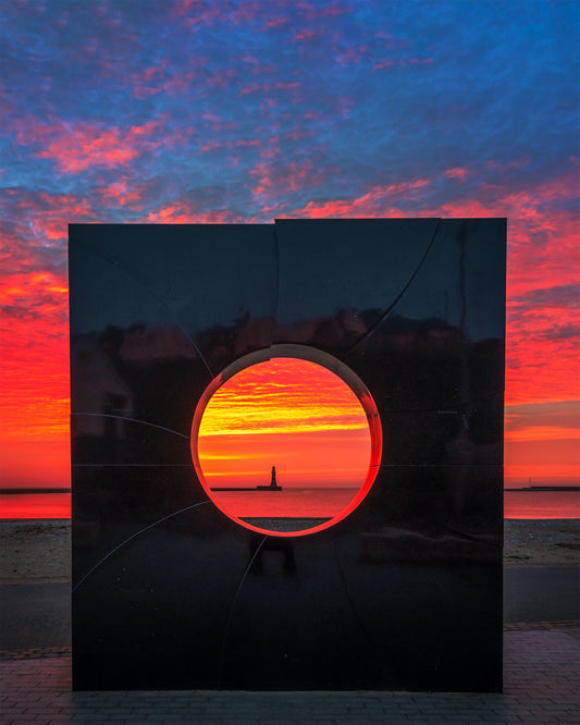Intense sunrise colours through the Roker Porthole.