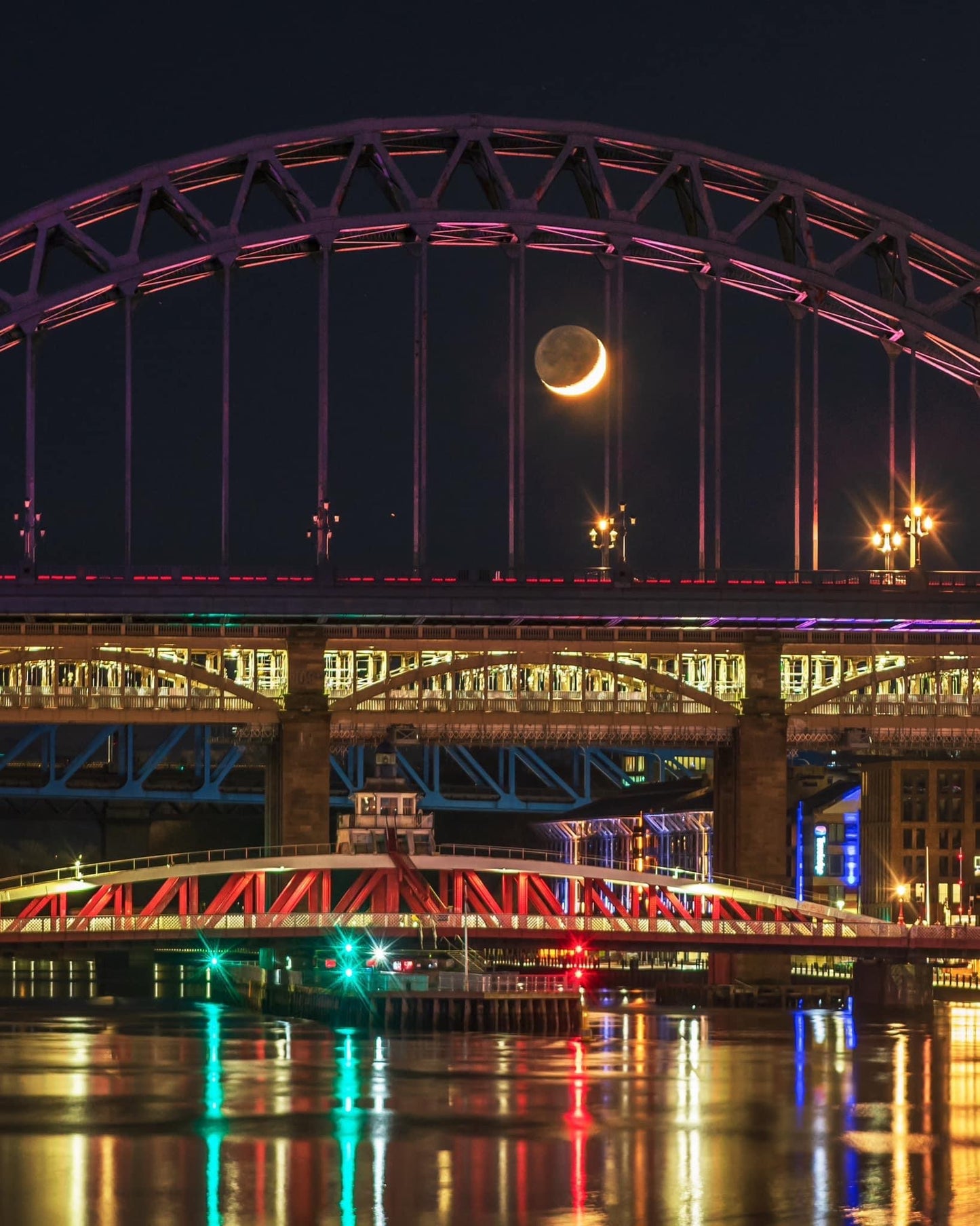 A lovely crescent moon between the bars of the Tyne Bridge.