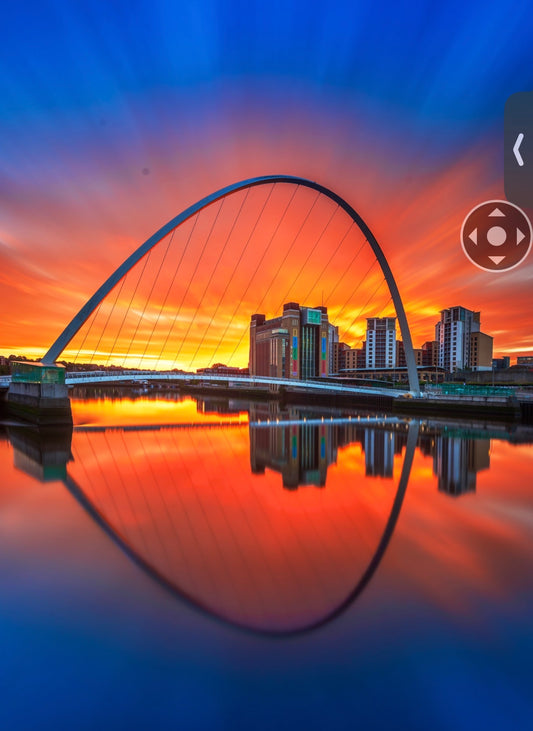 Dramatic sunrise sky over Millennium Bridge.