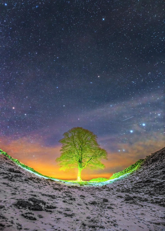 Walker's head lamp lights up  Sycamore Gap.