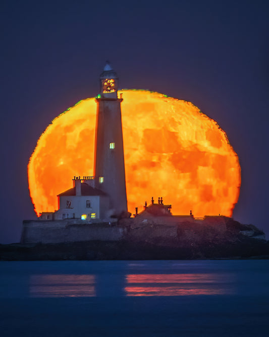 St. Mary’s Lighthouse in front of a   Huge moon.
