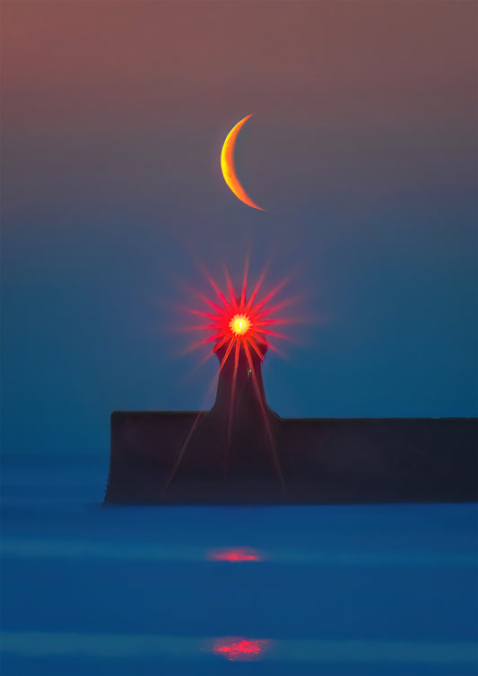 Crescent moon rising over South Shields lighthouse.
