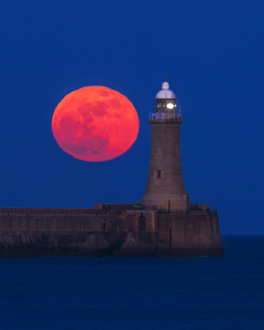 Red moon rising by Tynemouth Lighthouse.