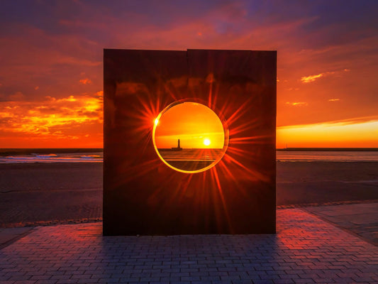 Dramatic sunrise through the Roker Porthole.