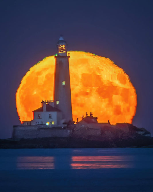 St. Mary’s Lighthouse in front of a   Huge moon.