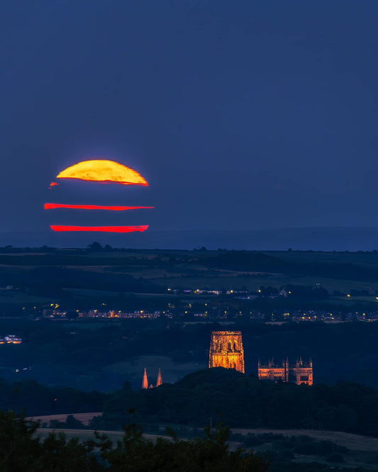 Durham Cathedral with stripy clouds across the full Buck Moon.