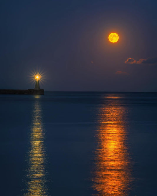 Moon and lighthouse reflections at Tynemouth.