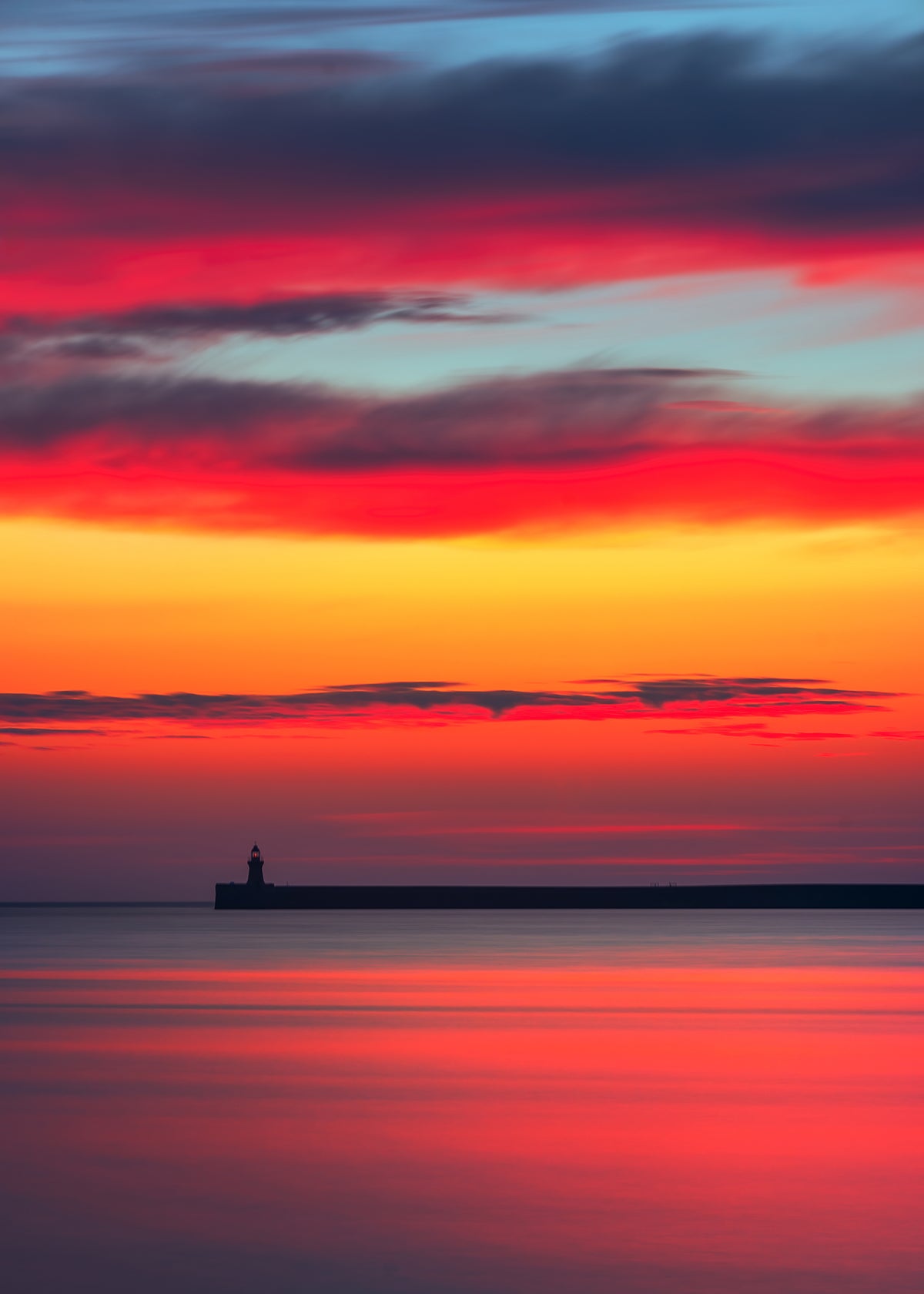 Beautiful sunrise colours over tiny mouth Lighthouse.