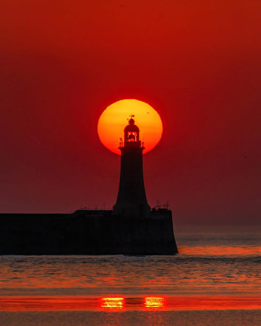 A summer solstice sunrise over Tynemouth Lighthouse.