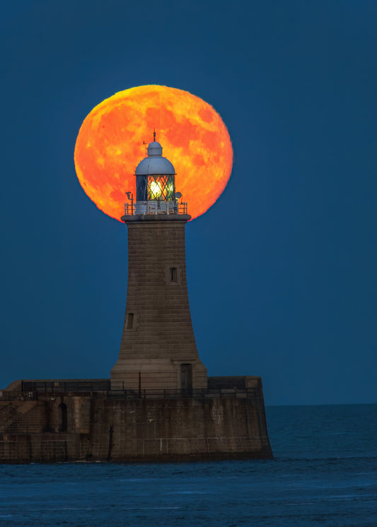 The full moon nestled on Tynemouth Lighthouse.