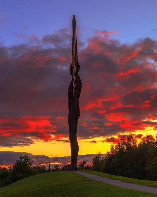 Side view of the Angel of the North during a stunning sunset.