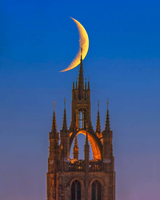 A waxing crescent moon over Newcastle Cathedral.