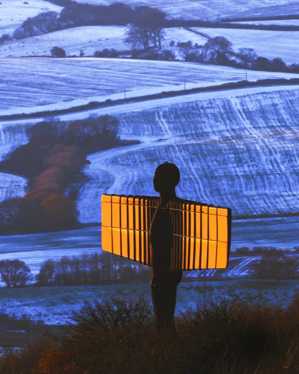 The Angel of the North gleaming in a snowy scene.