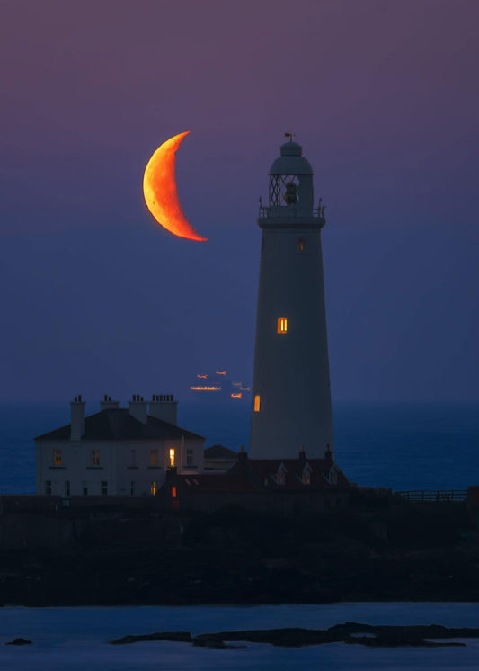 A crescent moon beside St.Mary’s Lighthouse.
