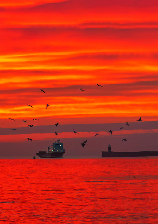 A beautiful sunrise as the fishing boat comes in.