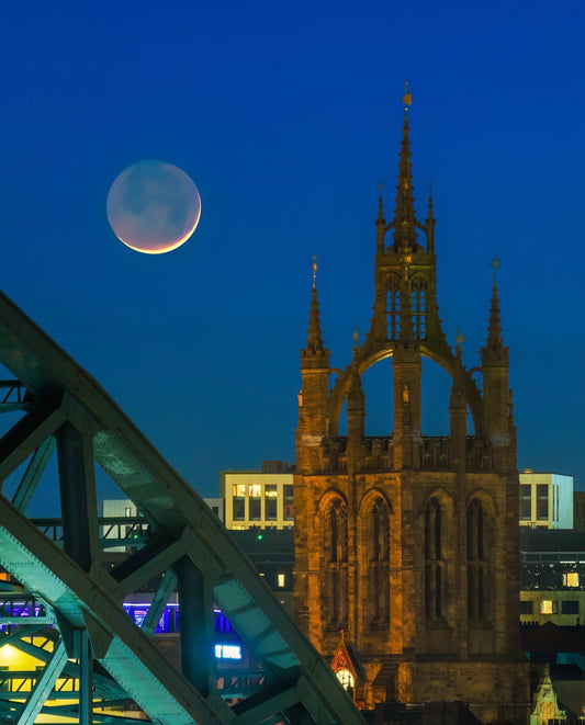 The new moon with the Tyne Bridge and St. Nicks Cathedral.