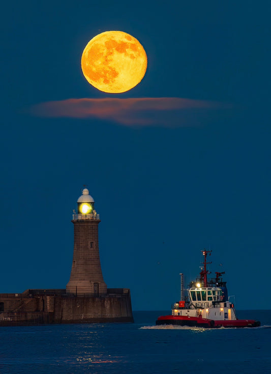 Full moon, a lighthouse and a boat.