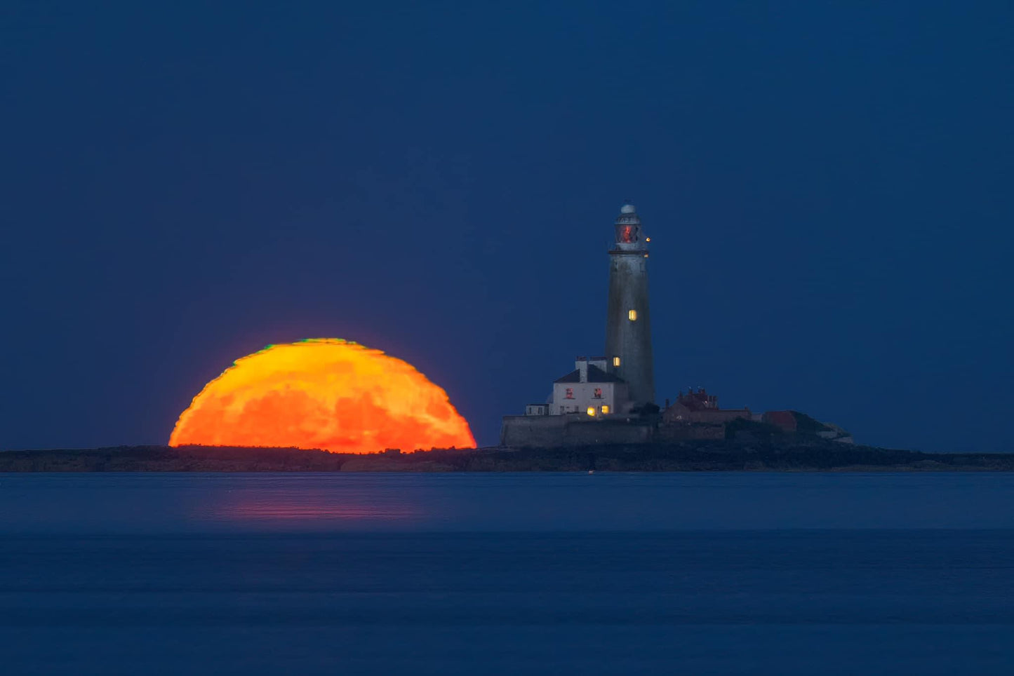 The moon and St.Mary’s lighthouse side by side.